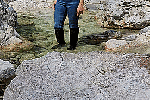 Paroshbrowncowgirlbootsfloodedinrockystream